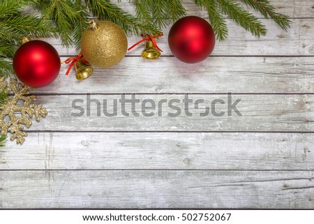 Spruce branches with Christmas ornaments on the wooden background. Space for text.