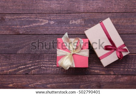Christmas Composition with Gift box and light, red balls on wooden table.