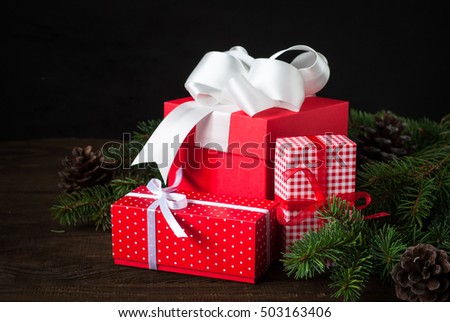 Beautiful christmas presents in red boxes  at wooden table.