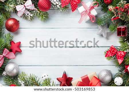 Christmas wooden background with snow fir tree and decoration. Top view with copy space for your text