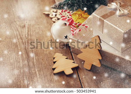 Decorative wooden christmas tree next to gift boxes. Selective focus