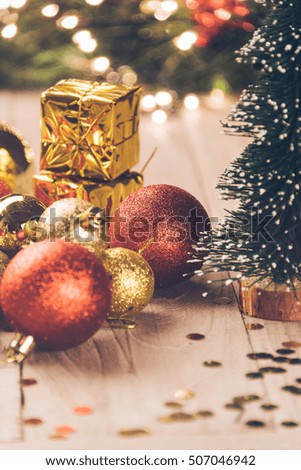christmas decorations and green present on wood.