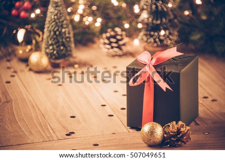 christmas decorations and green present on wood.
