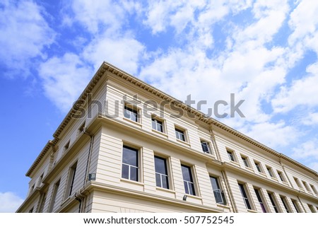 The light brown building with the sky and cloud.The vintage building with the sky and cloud