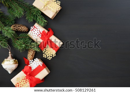 Christmas gifts with Christmas tree branch on wooden table with free space for greetings