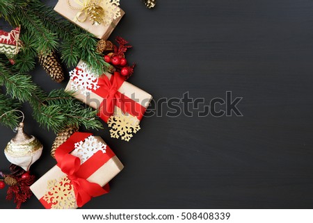 Christmas gifts with Christmas tree branch on wooden table with free space for greetings