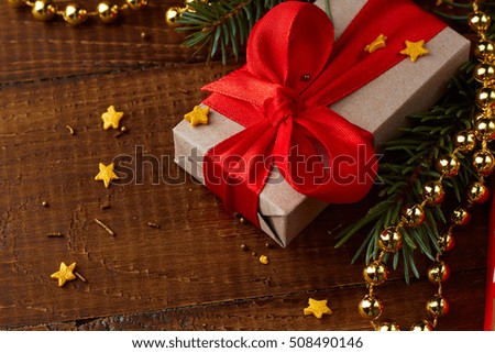 Christmas gift boxes with decorations on wooden board