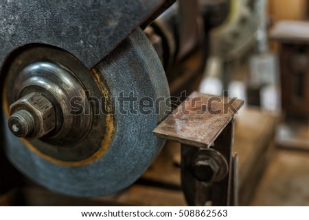 Close up board, emery wheel in workshop
