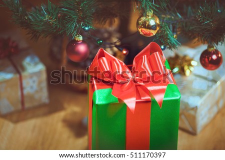  Christmas presents under a Christmas tree with defocused lights