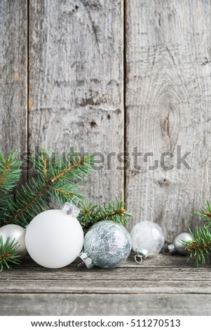 Silver and white christmas ornaments, xmas tree on rustic wood background. Merry christmas card. Winter holiday theme. Happy New Year. Space for text.