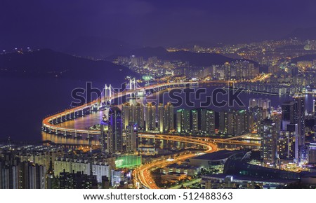 Busan,GwangAn Bridge and Haeundae in South Korea aerial view at night.