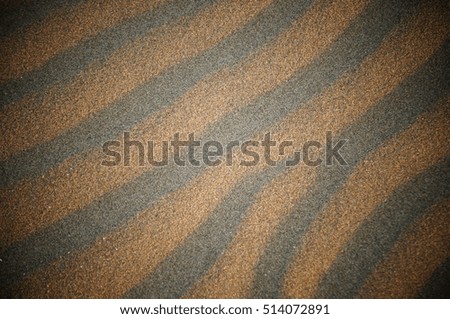Tiger-striped patterns in the sand created by wind and waves on Chesterman Beach along the Pacific Ocean near Tofino