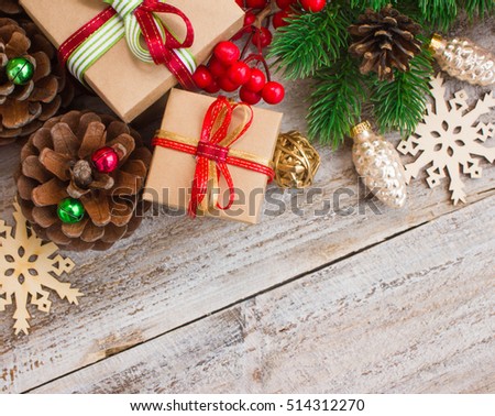 Christmas or New Year background: gifts, colored glass balls, decoration and cones on wooden background