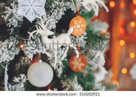 Green decorative christmas tree with figure of deer, vintage toned, close-up