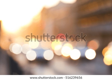 Blurred sunset light in city street with cars