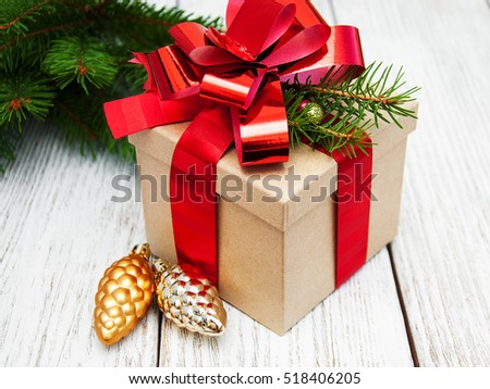 christmas gift box with decorations on a old wooden background