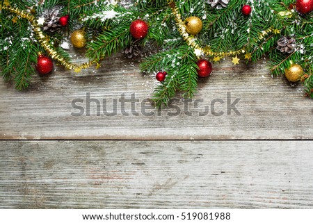christmas fir tree with decorations on rustic wooden background