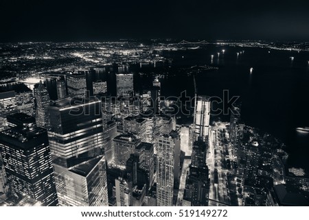 Rooftop night view of New York City downtown with urban skyscrapers