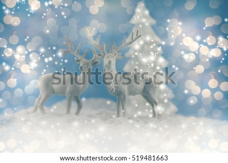 A winter Christmas scene with white deers.