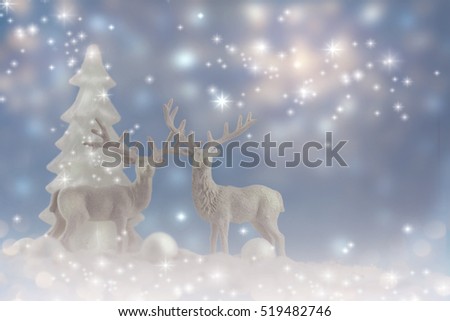 A winter Christmas scene with white deers.
