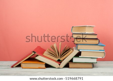 Open book, hardback colorful books on wooden table. Back to school. Copy space for text