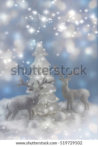 A winter Christmas scene with white deers.
