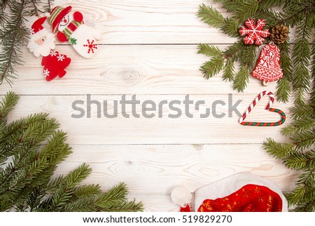 Christmas New Year holiday background. Gingerbread cookies, Santa Claus hat, snowman, Santa and fir branch tree on white table. Top view