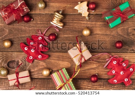 Christmas ornaments and gifts on a wooden background.