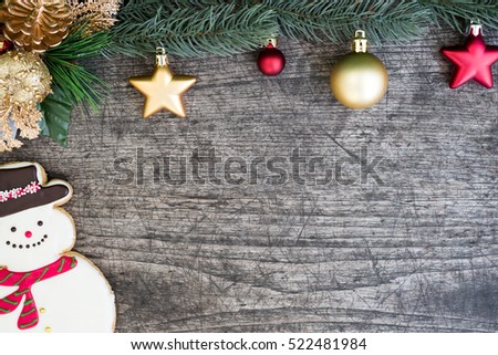 Snowman cookie and christmas tree decorate with red and gold ornament on wooden table background with copy space for text, Greeting card style for merry xmas and happy new year
