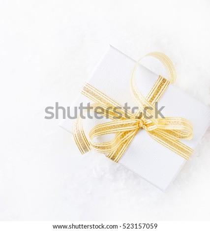 White Christmas present with golden ribbon