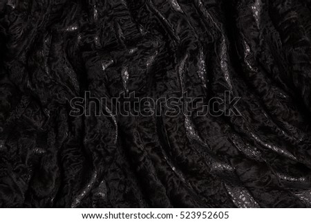 Texture of black fur. Karakul skin. Background.