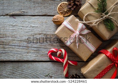 Christmas presents in decorative boxes, white wood background
