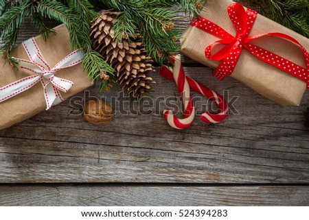 christmas presents in decorative boxes, white wood background