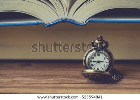 Pocket Watch in Front of Book with Blank Space in Vintage Tone