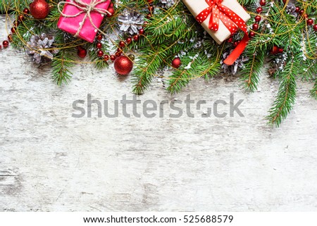 christmas background with decorations and gift boxes covered with snow on white wooden background with copy space