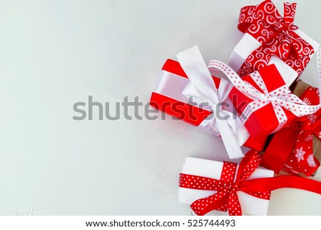 Gift box tied with a red ribbon , fir  branches,candy and christmas ball on the white background. Christmas card