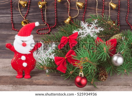 decorated Christmas fir branch on a dark wooden background