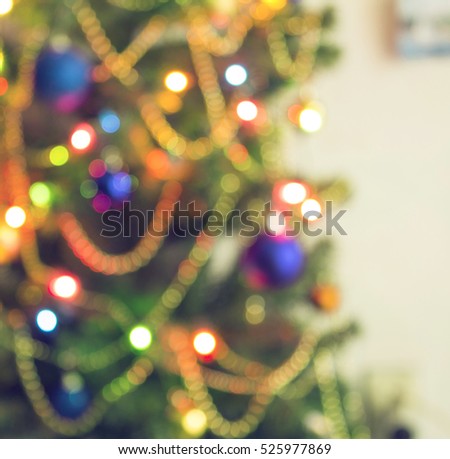 Abstract christmas background with christmas tree with decorations, defocused bokeh lights.