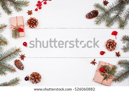 Christmas background with Christmas gift, fir branches, pine cones, snowflakes, red decorations. Xmas and Happy New Year composition. Place for text. Flat lay, top view