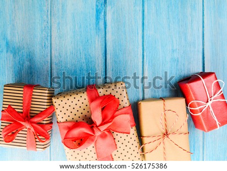Christmas or New Year decorated gift boxes on blue wooden background