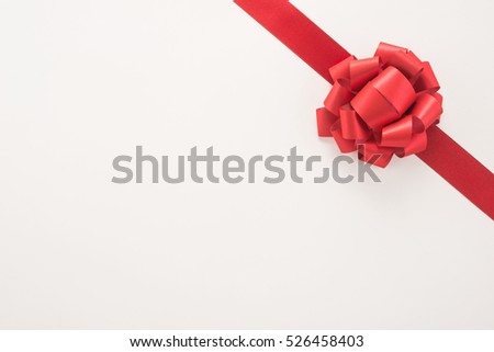 Decorative red ribbon and bow on a white background