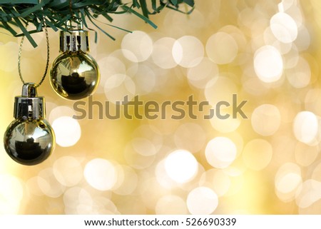 Christmas ball ornament decoration on fir tree over gold circle bokeh blurred light background with copy space for text, greeting card new year