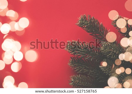 Christmas background with fir tree branches and bokeh blurred fairy lights