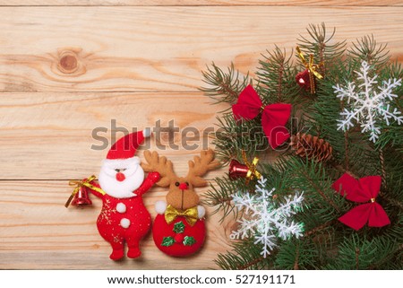 decorated Christmas fir branch on a light wooden background