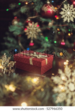 New Year's gift under the Christmas tree, Christmas tree ornaments and garland