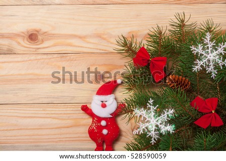 decorated Christmas fir branch on a light wooden background