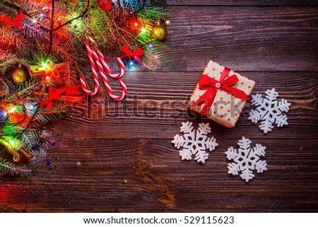 Christmas wooden background decorated by snow tree and gifts with copy space