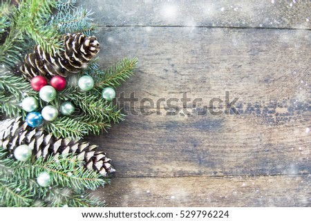 Pine, silver fir branches, pine cones, Christmas balls on rustic wooden background, Christmas, winter holiday background, space for text, natural, minimal Christmas mood, natural, discreet snow