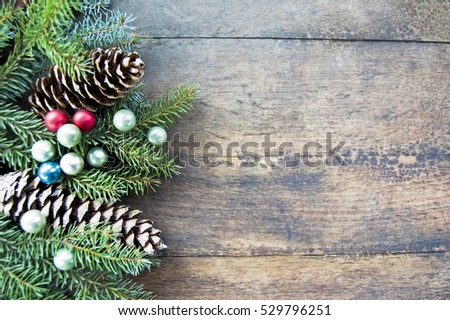 Pine, silver fir branches, pine cones, Christmas balls on rustic wooden background, Christmas, winter holiday background, space for text, natural, minimal Christmas mood