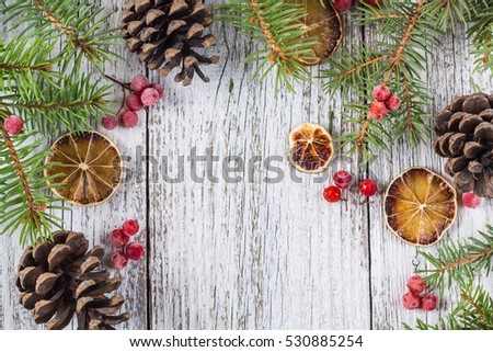 Christmas fir branches with cones viburnum berries and dry lemon slice. Top view with copy space for your text
